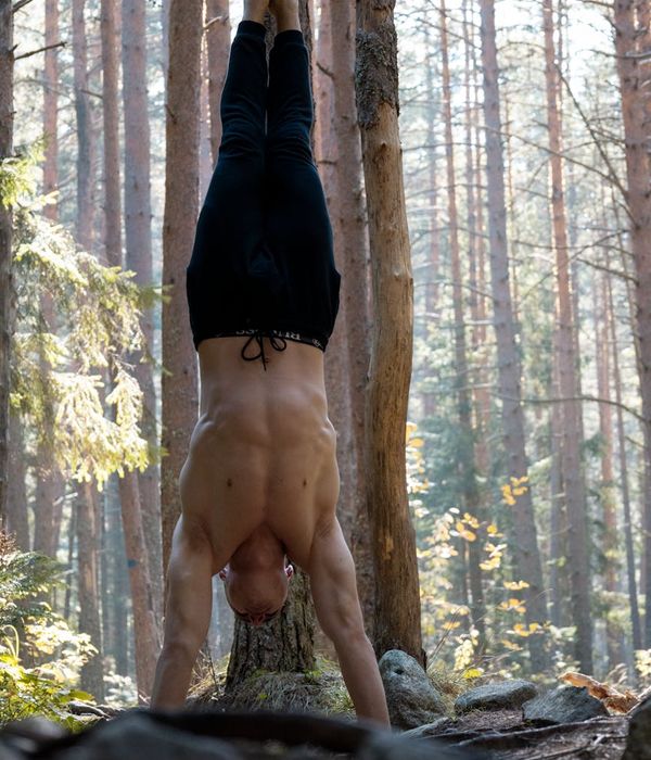 Man performing a strength exercise in a calm, focused environment.